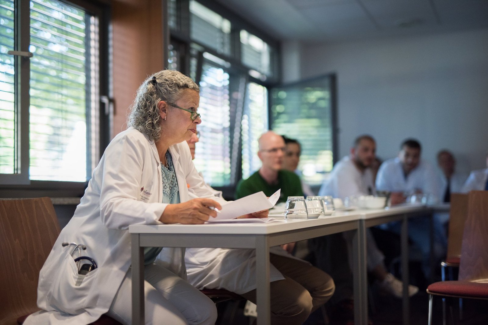 Ärztinnen und Ärzte sitzen in der Konferenz zum fachübergreifenden Austausch Ärztinnen und Ärzte sitzen in der Konferenz zum fachübergreifenden Austausch